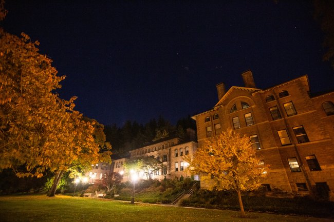 Western's Old Main lit up at night.