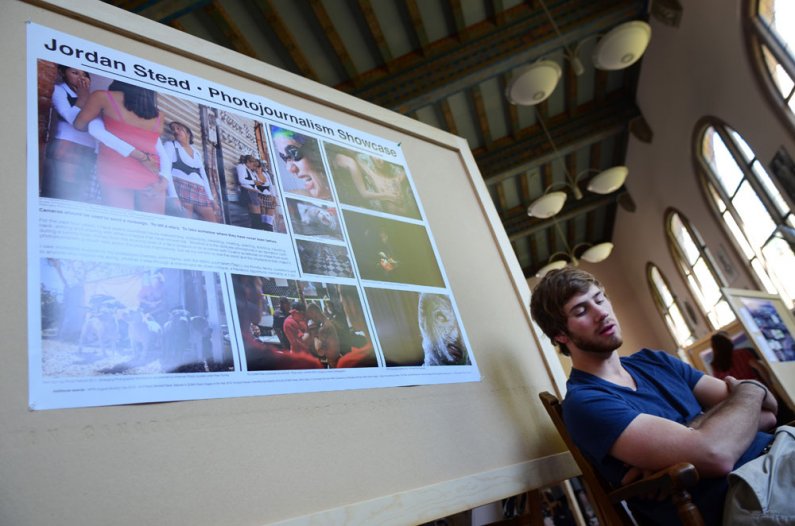 Western senior Jordan Stead, a visual journalism major, discusses his photojournalism and internship work from California and Washington state during a Scholars Week presentation Friday, May 20, in the Wilson Library Reading Room. Photo by Daniel Berman |