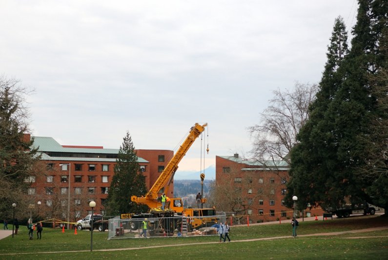 The 'Untitled' sculpture by Donald Judd, which has sat on the Old Main lawn since its installation there in 1983, is prepared for loading to a flatbed truck Thursday morning, Dec. 5, for a move to Seattle for restoration and eventual resiting on south cam