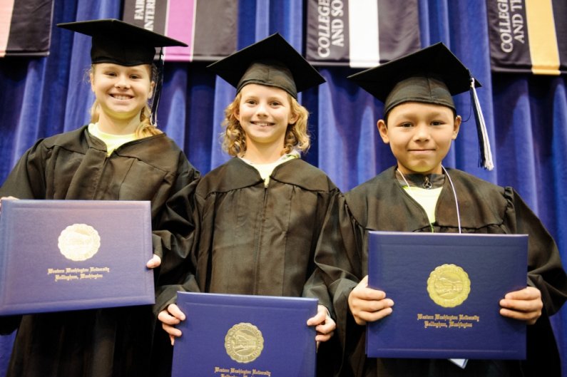 Three Compass 2 Campus students are awarded diplomas to help them imagine what it will be like to graduate from college. From left to right, they are Hailey Wison (Blaine Elementary), Destiny Dunlap (Nooksack Elementary) and Adrian Bueno (Fisher Elementar