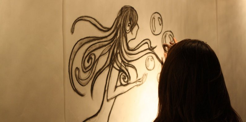 WWU student Lauren Gordon uses charcoal to draw a mermaid in the VU Gallery's 'Drawing Jam' exhibition. The opening reception is April 5 from 6 to 8 p.m. Photo by Shea Taisey | University Communications intern