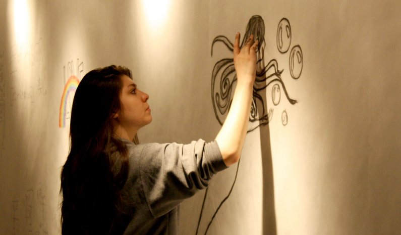 WWU student Lauren Gordon uses charcoal to draw a mermaid in the VU Gallery's 'Drawing Jam' exhibition. The opening reception is April 5 from 6 to 8 p.m. Photo by Shea Taisey | University Communications intern