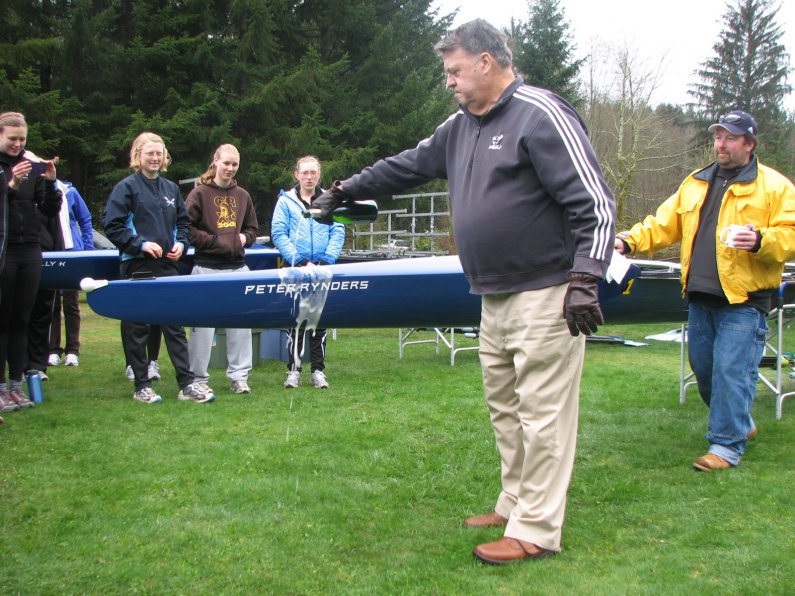 Peter Rynders, a longtime friend of WWU Athletics, christens the "Peter Rynders," Western's newest eight-person shell. Courtesy photo
