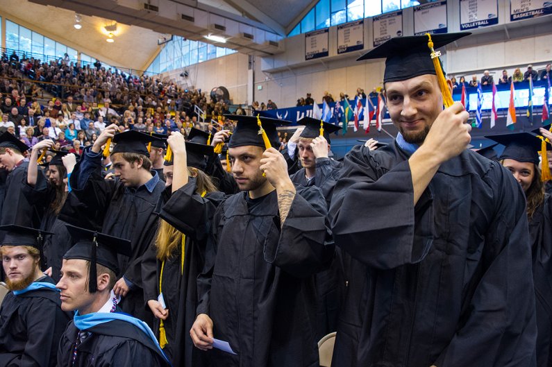Graduating seniors turn their tassels at winter commencement Saturday, March 23, 2013, signifying their new status as graduates of Western Washington University. Photo by Dan Levine | for WWU