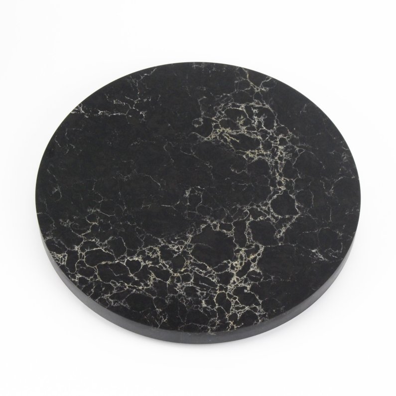 The image is a round black marble disc. The marble has white and gold veins. The table is smooth and polished. It is sitting on a white background.