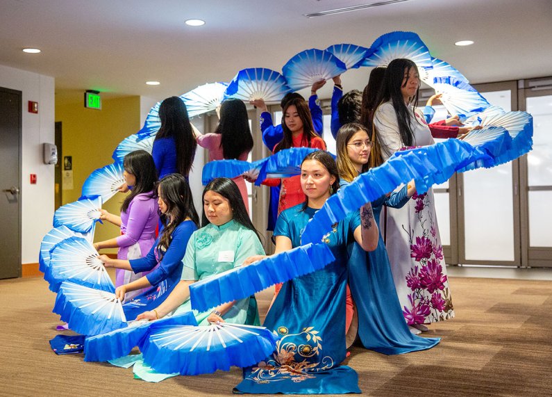 Students perform an Asian "fan dance"