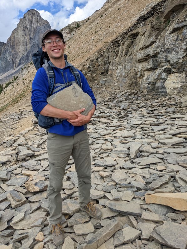 Paul Striby stands smiling on a rocky mountainside