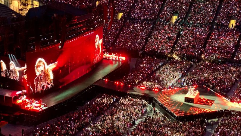 High-level shot of Lumen Field lit in red with Taylor Swift performing in front of tens of thousands of fans in July 2023. Photo by Kari Mar, '98, who attended the concert with her niece, an incoming WWU freshman. 