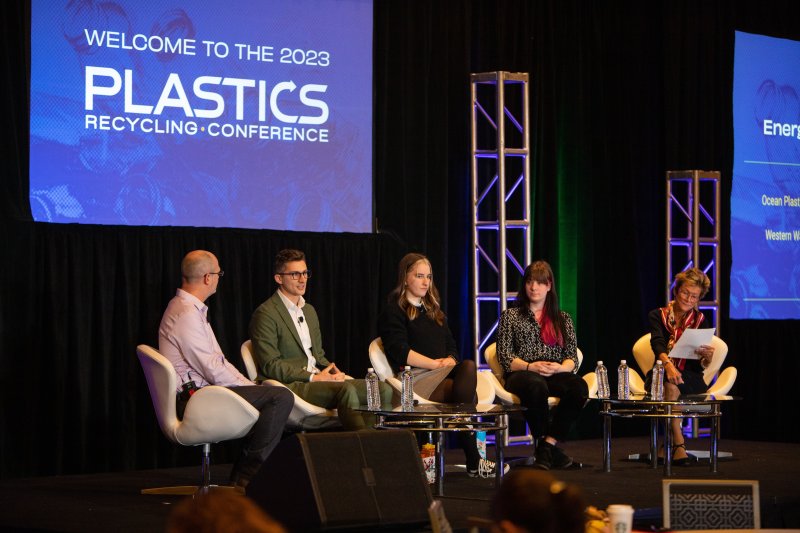 Students on a stage at a plastics conference
