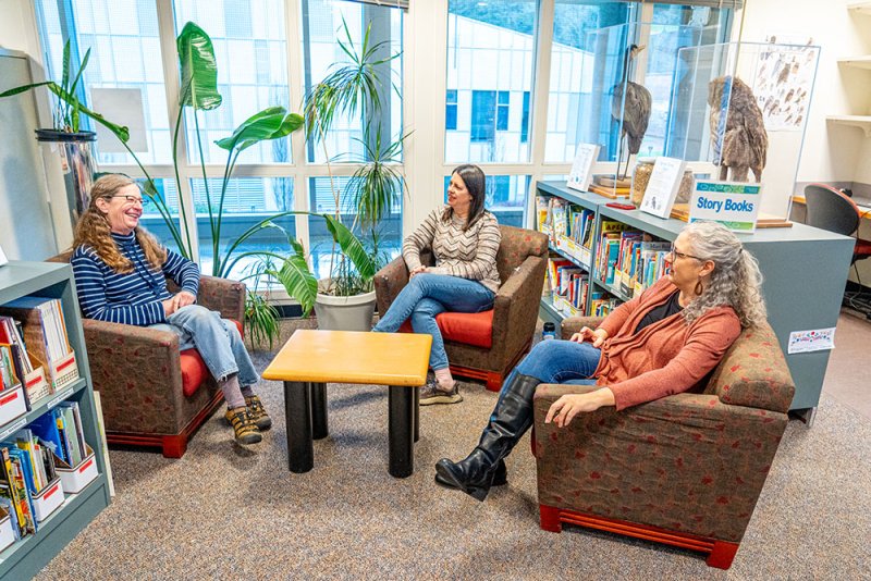  Emily Borda, Tracy Coskie and Shannon Warren relax in a reading area and talk about their new grant.