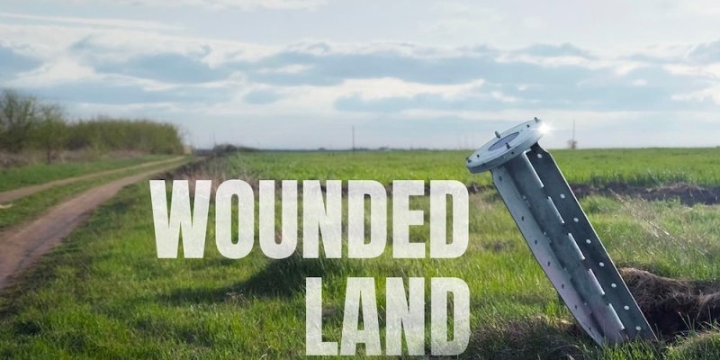 Wounded Land movie poster shows a unexploded missile sticking out of a grassy field.