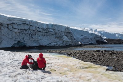 Western's Alia Khan and Chilean colleague Edgardo Sepulveda collect spectra albedo measurements in front of Collins Glacier on King George Island in Antarctica