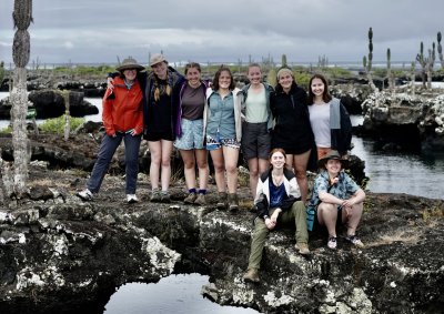 Students pose for a photo on one of the land bridges that connects Los Tuneles off Isabela Island.