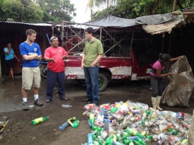 WWU's Josh Fisher, in green shirt above, talks with the owner of a recycling business near a city dump in Cuidad Sandino, Nicaragua.