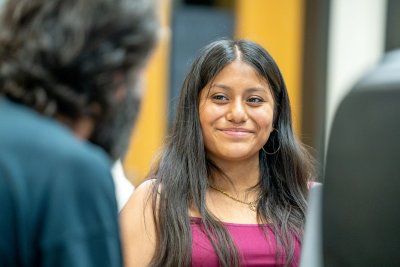 Leslie Solano smiles as she talks to WWU Assistant Professor of Biology Nick Galati.