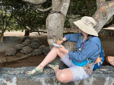 WWU student Kate Lincoln takes notes while watching a group of tortoises at a breeding facility on Isabela Island.