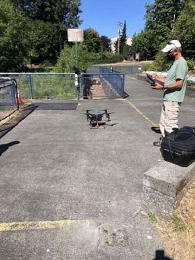 Huxley's David Wallin sets up a drone for a test flight over Whatcom Creek