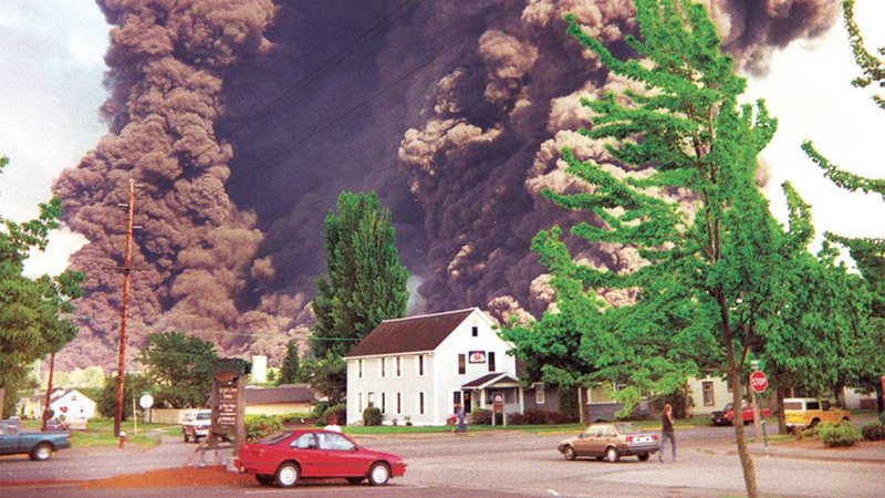 A residential area is covered in ash and smoke from a nearby pipeline eruption.