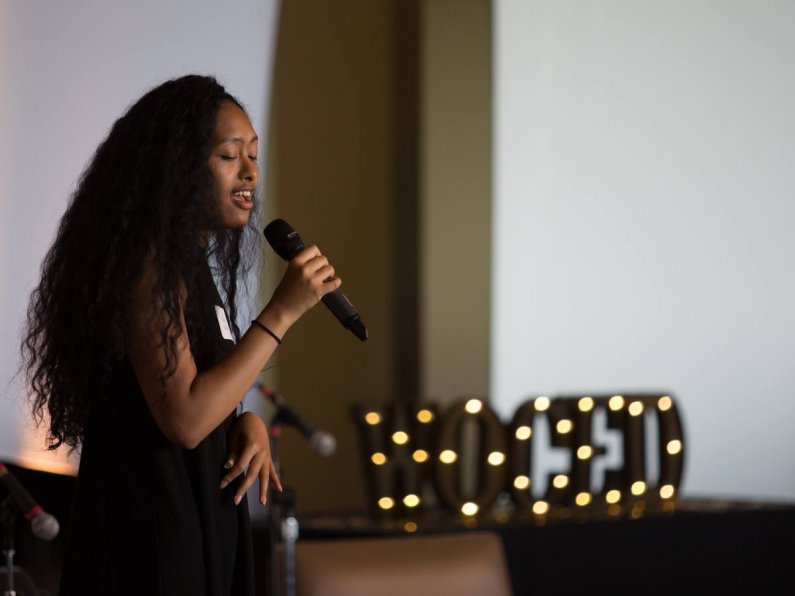 Student Kalia Castro sings at the Women of Color Empowerment Dinner Friday, May 13. Photo by Jonathan Williams / WWU