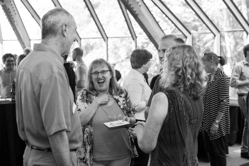 Attendees of John Lawson's retirement party June 30 share a laugh in the Old Main Solarium. Lawson is retiring after 10 years at Western. Photo by Jonathan Williams / WWU