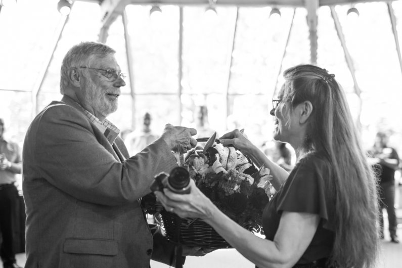 After commenting that his wife Sue Ann is the biggest reason he's had success as CIO at three different universities, John Lawson presents her with flowers. The two have been married for 45 years. Photo by Jonathan Williams / WWU