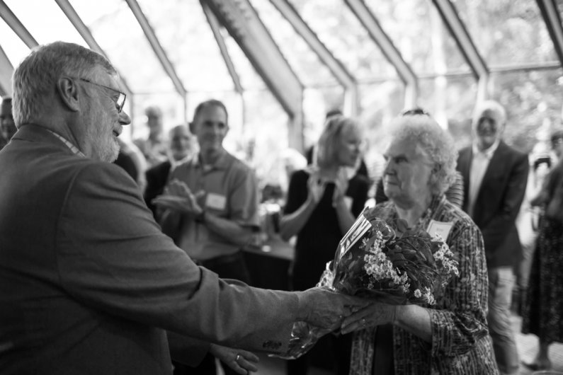 John Lawson hands flowers to his mother, Wilma, at a retirement celebration held in his honor June 30, 2016, at Western Washington University. Wilma Lawson told a few stories of her son in his youth at the ceremony. Photo by Jonathan Williams / WWU