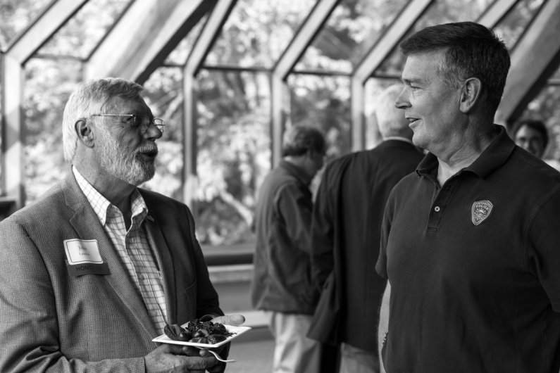 John Lawson, left, talks with University Police Chief Darin Rasmussen at a retirement party held for Lawson June 30, 2016. Photo by Jonathan Williams / WWU