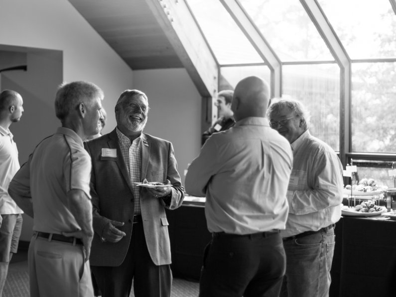 John Lawson, second from left, chats with (left to right) Steve Swan, vice president for University Relations and Community Development; Bob Schneider, recently retired from Administrative Computing Services; and Frank Roberts, recently retired from ATUS.