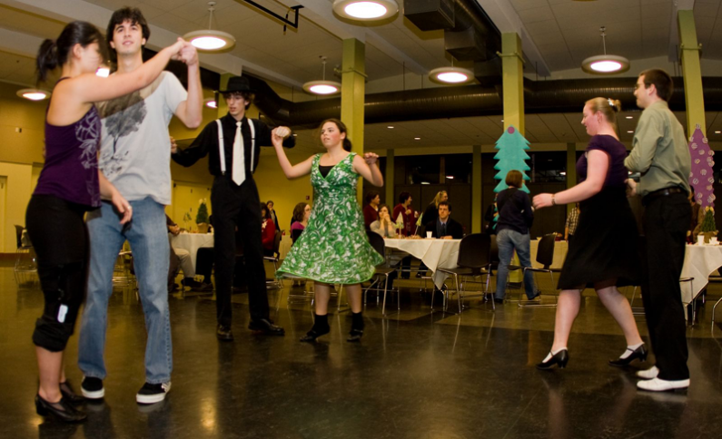 Members of the Associated Students Swing Kids club show off the dancing skills to the delight of Western's faculty and staff at the University's holiday party. Photo by Jon Bergman | WWU intern
