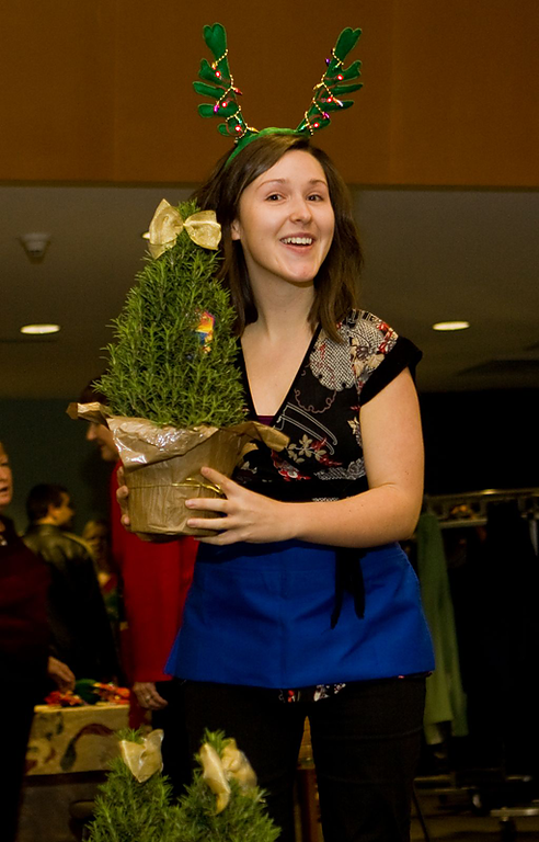 Western theology student Leah Bangs hands out rosemary topiaries as door prizes to Western's faculty and staff at the university's holiday party. Photo by Jon Bergman | WWU intern