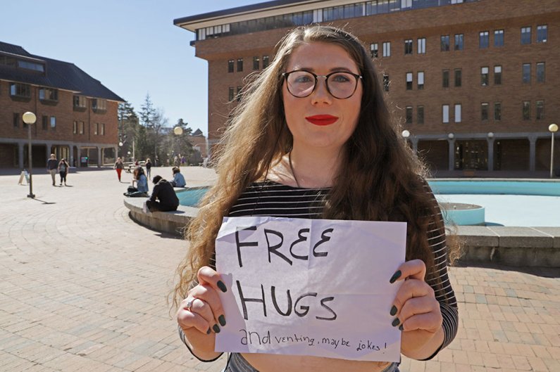 Sophomore Torria Petrize stands in Red Square on Tuesday, March 19 giving hugs to those who may need a little extra encouragement during finals week. Petrize stood in Red Square giving out hugs for a full five hours the previous day. 