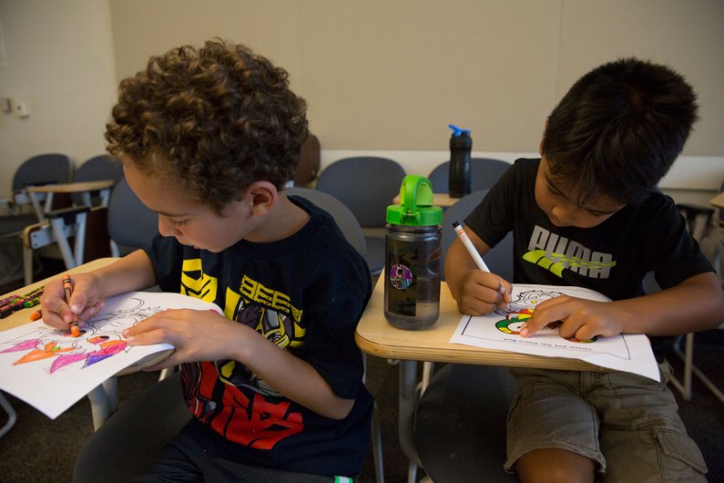Best friends Evan and Taye work on coloring in their Chinese dragon masks on Tuesday, July 14, 2015. Photo by Alex Bartick / WWU Communications and Marketing intern