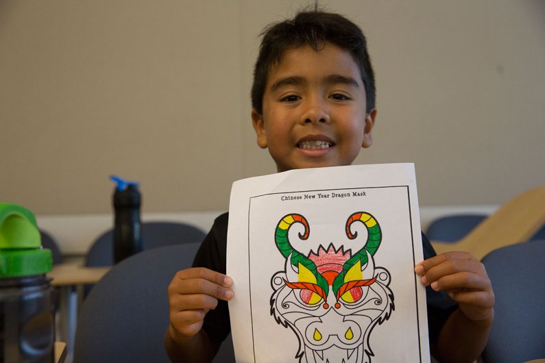 Second grader Taye shows off the progress on his Chinese dragon mask on Tuesday, July 14, 2015. Students at Western’s Kids Camp were making their own dragon masks as a part of the week's Art Around the World theme. Photo by Alex Bartick / WWU Communicatio