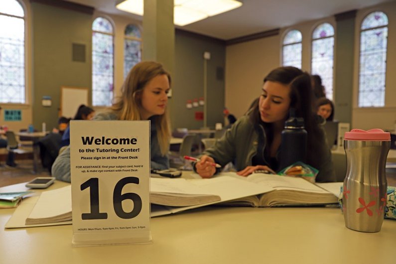 Sophomores Holly Valgardson and Emily Hinojosa utilize the quiet space and academic support of the Tutoring Center in Wilson Library to study for their Math 115 class. 