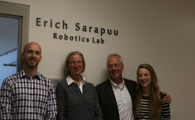 Erich Anderson, Ingrid Sarapuu, Michael Anderson and Stacy Anderson stand in front of the entrance to the Erich Sarapuu Robotics Lab.  Photo by Amanda Raschkow / WWU Communications intern